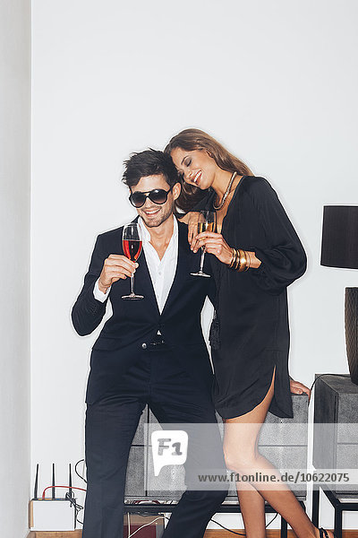 Stylish young couple with drinks