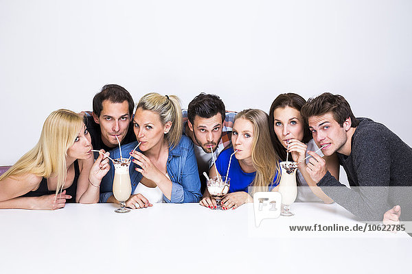 Group of friends drinking milkshakes