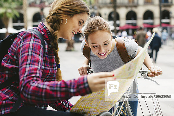 Spanien  Barcelona  zwei junge Frauen mit Fahrradkarte in der Stadt