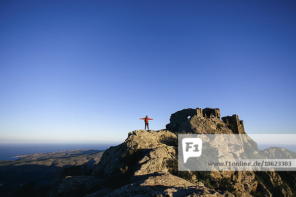 Spain  Catalunya  Girona  female hiker on mountaintop enjoying the nature