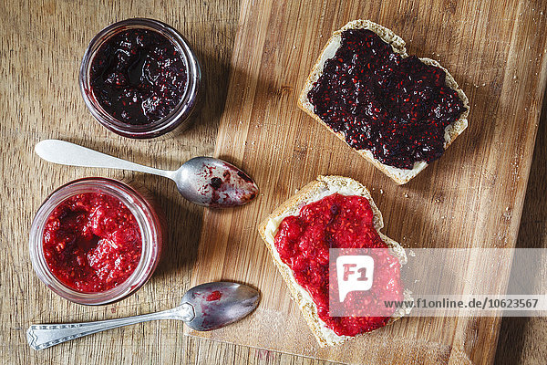Homemade raspberry and blackberry jam with chia seeds  slices of bread