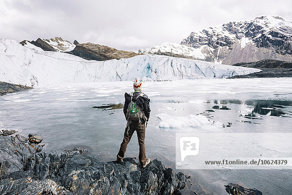 Man with backpack admiring the Pastoruri glacier