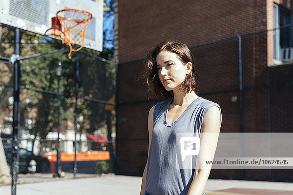 USA  New York City  Manhattan  young woman standing on a playground