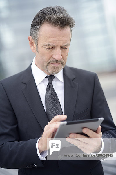 Young businessman using digital tablet