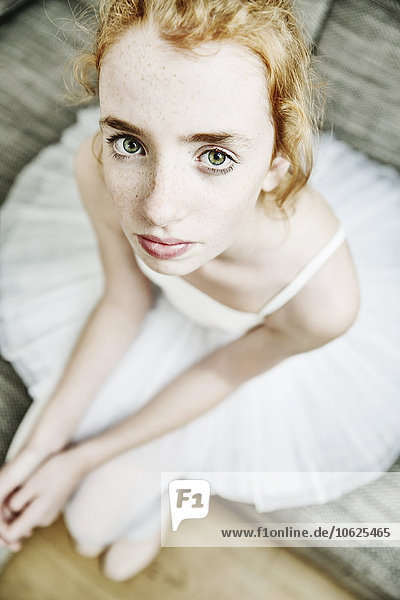 Portrait of a girl wearing tutu looking up to camera