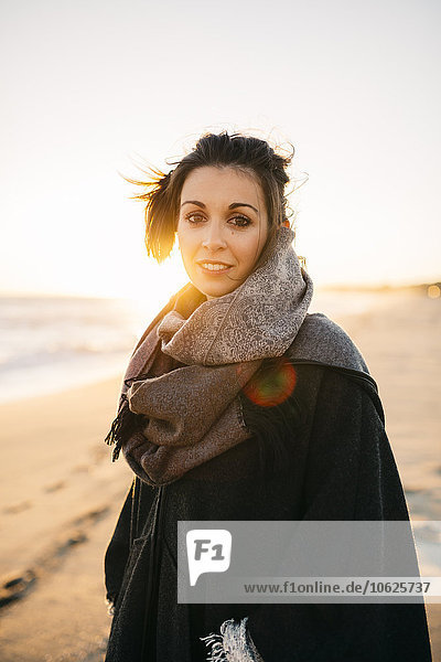 Porträt einer jungen Frau am Strand im Winter