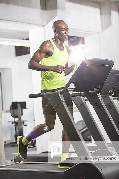 Athlete running on treadmill in gym