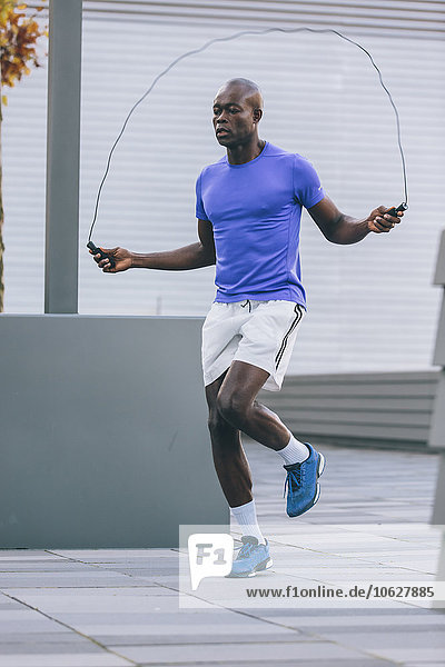 Athlete skipping rope outdoors