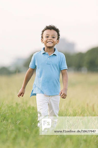 Portrait of smiling boy in field
