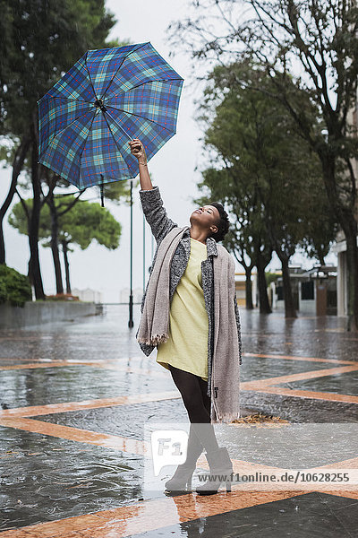 Italy  Grado  woman with umbrella on a rainy day in autumn