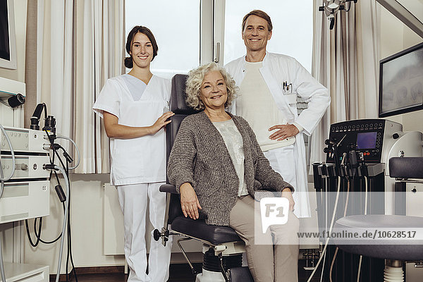 Senior patient in ENT clinic with doctor and nurse