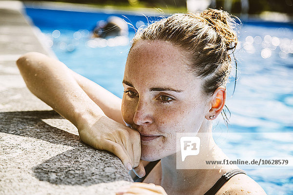 Portrait of female swimmer at pool edge