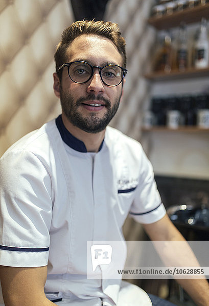 Portrait of barber with full beard and glasses