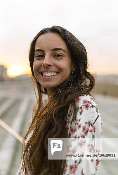 Portrait of smiling woman at evening twilight