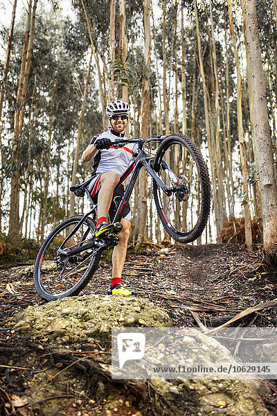 Smiling mountain biker in the forest