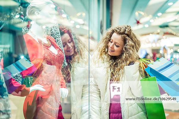 Italy  Lombardy  Milan  Woman with shopping bags in a shopping center