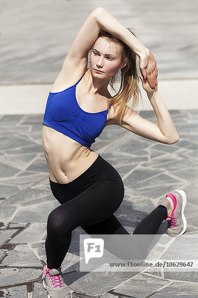 Young woman doing workout in the city