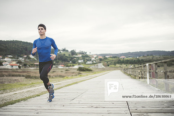 Spain  Ferrol  jogger running on a boardwalk