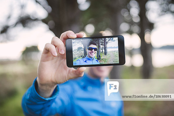 Selfie of a runner on the display of a smartphone