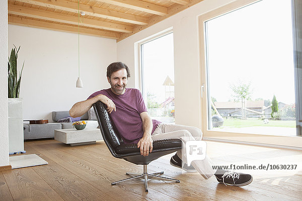 Mature man sitting relaxed in his living room