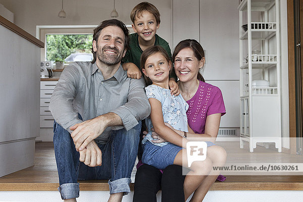 Happy family sitting on kitchen steps