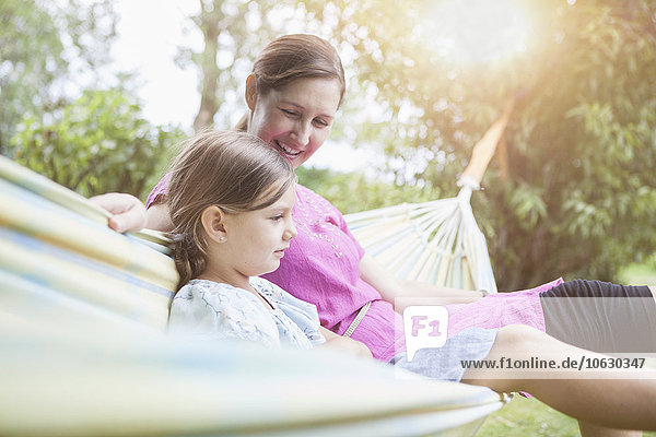 Relaxed mother and daughter in hammock