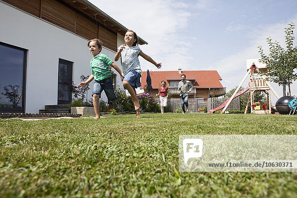 Carefree family running in garden