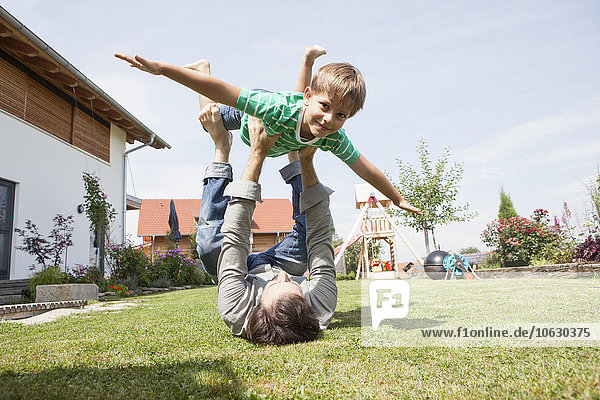 Playful father with son in garden