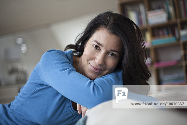 Portrait of smiling relaxed woman at home