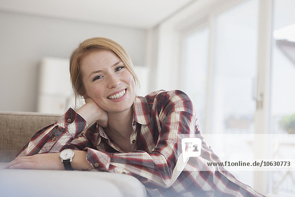 Portrait of smiling young woman relaxing at home