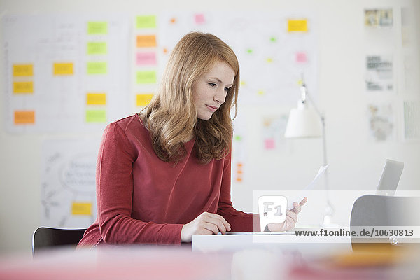 Young woman in office  working at desk