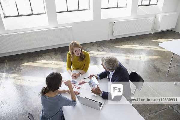 Businessman and two women in conference room having a meeting