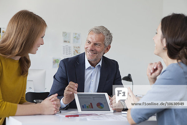 Businessman and two women in office having a meeting