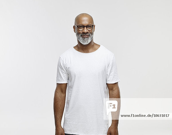 Portrait of smiling bald man with beard wearing spectacles and white t-shirt