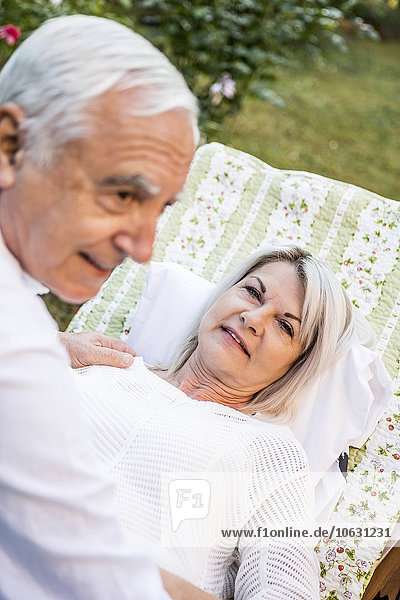 Relaxed elderly couple in garden