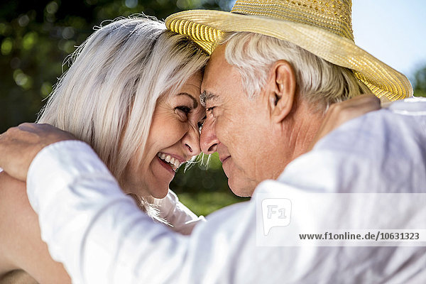 Tender elderly couple outdoors