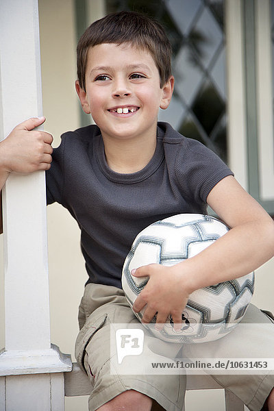 Portrait of smiling little boy with soccer ball