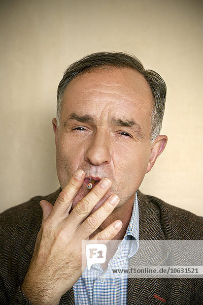 Portrait of man smoking cigarillo