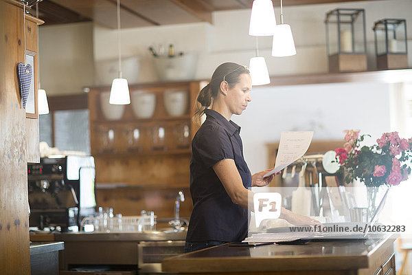 Waitress preparing bill at counter