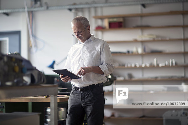 Man with digital tablet in a workshop
