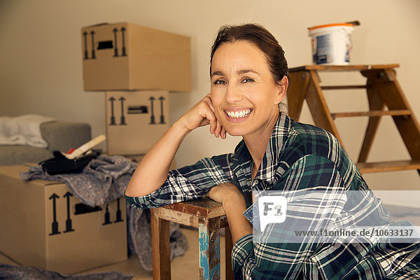 Smiling woman taking a break from moving house