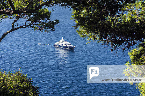 Italy  Capri  luxury yacht anchoring at steep coast