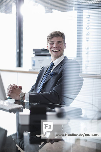 Happy businessman at desk