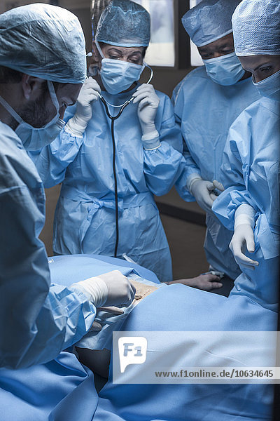 Surgical team operating patient