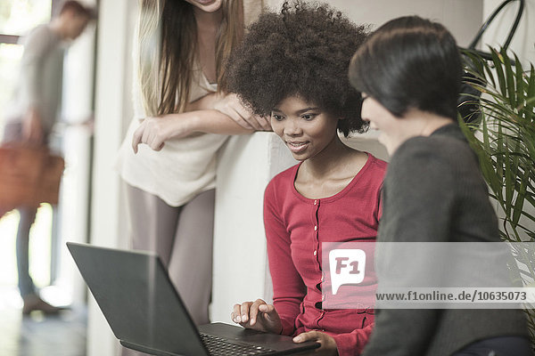 Young women looking at laptop