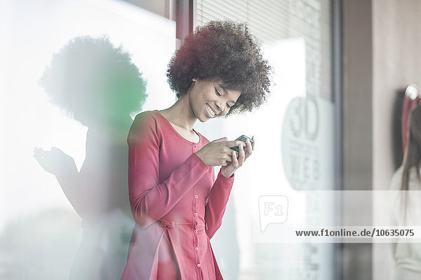 Young woman reading messages on smart phone