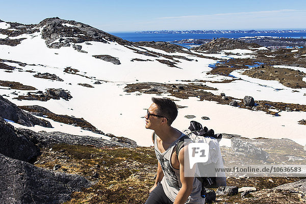 Hiker walking on snow covered mountain