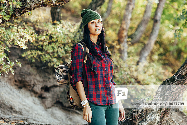 Portrait of confident woman hiking in forest