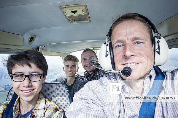 Porträt von Männern und Jugendlichen im Privatflugzeug