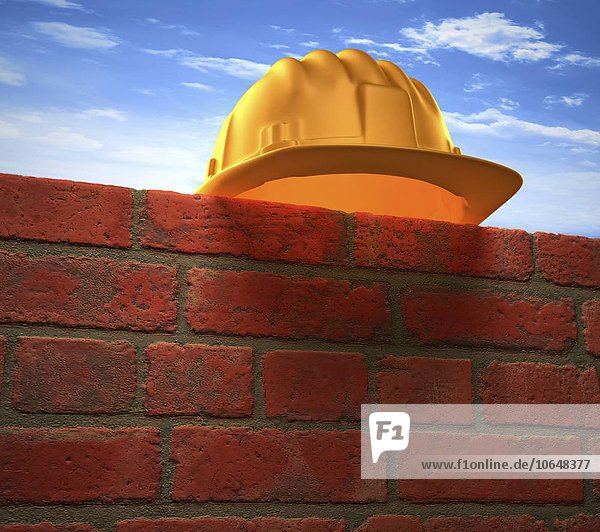 Hard hat on a brick wall,  artwork